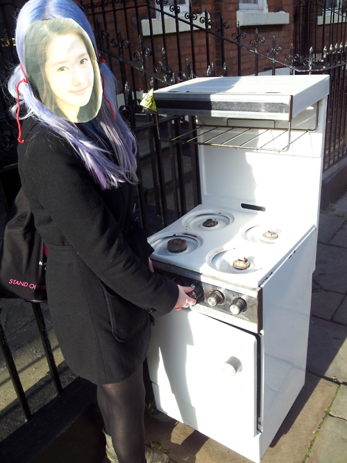 Yoona in street with abandoned oven